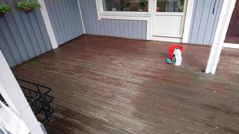 Weathered grey backyard deck boards in Ottawa before staining