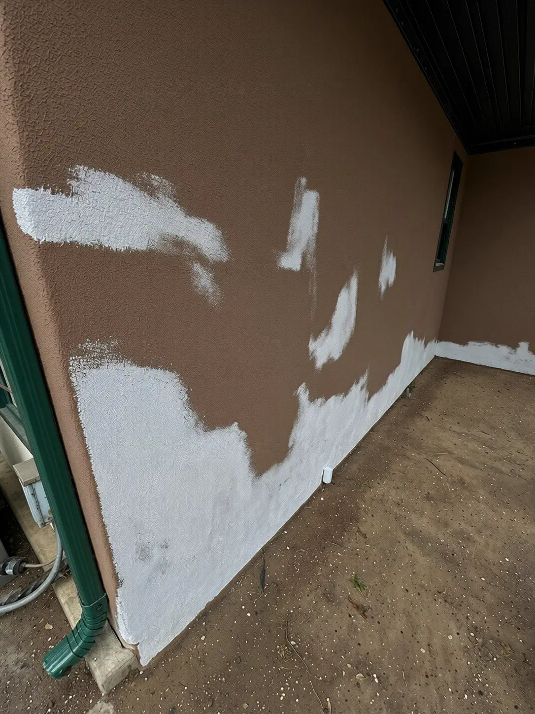 Patched and repainted stucco wall on an Ottawa house exterior