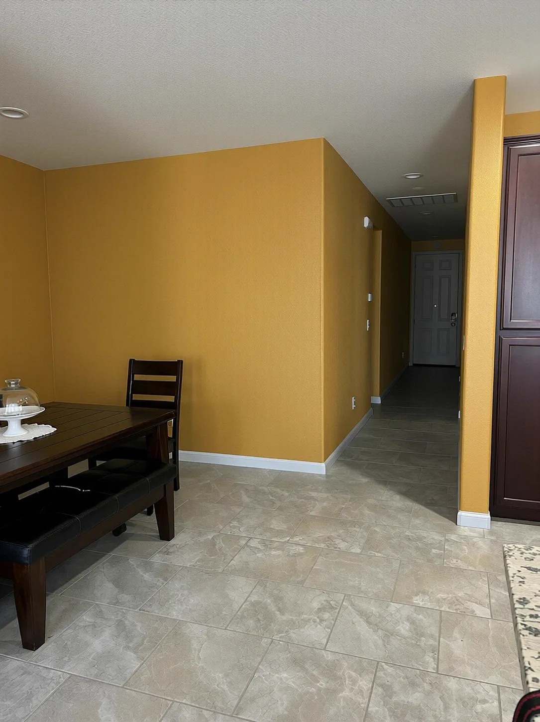 Dining room with a deep accent wall and white trim in an Ottawa home